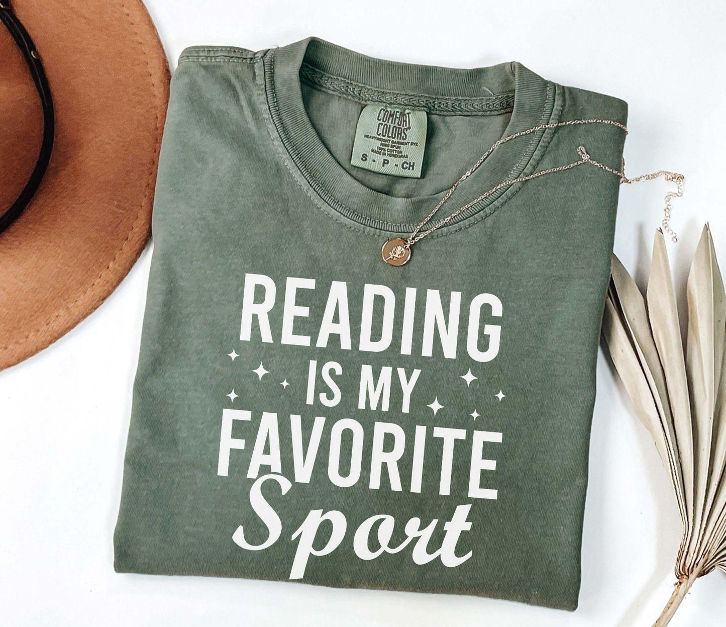 A comfort colors® shirt with the saying "Reading is my favorite sport"