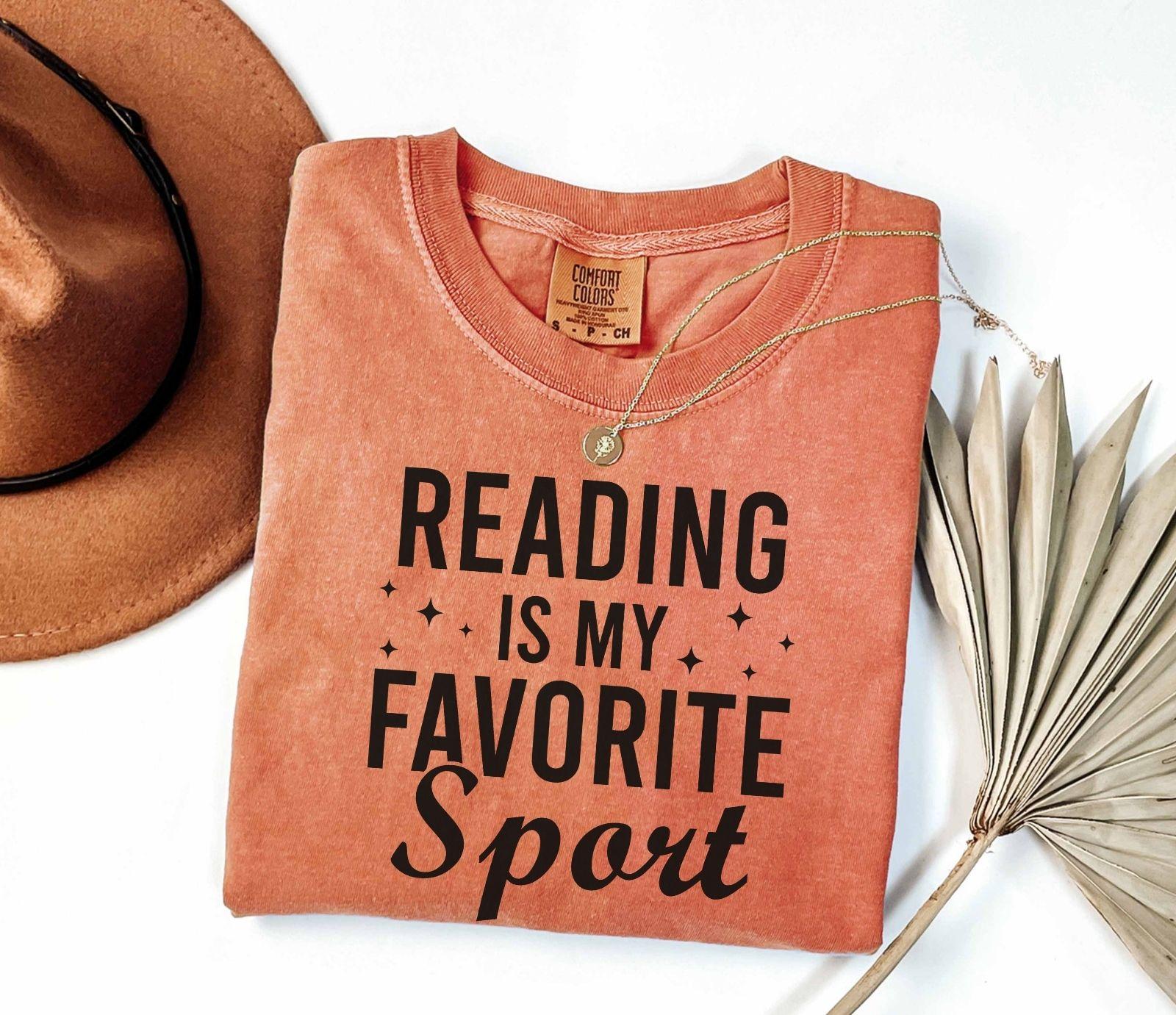 A comfort colors® shirt with the saying "Reading is my favorite sport"