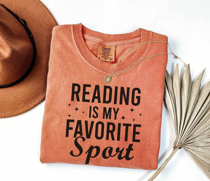 A comfort colors® shirt with the saying "Reading is my favorite sport"