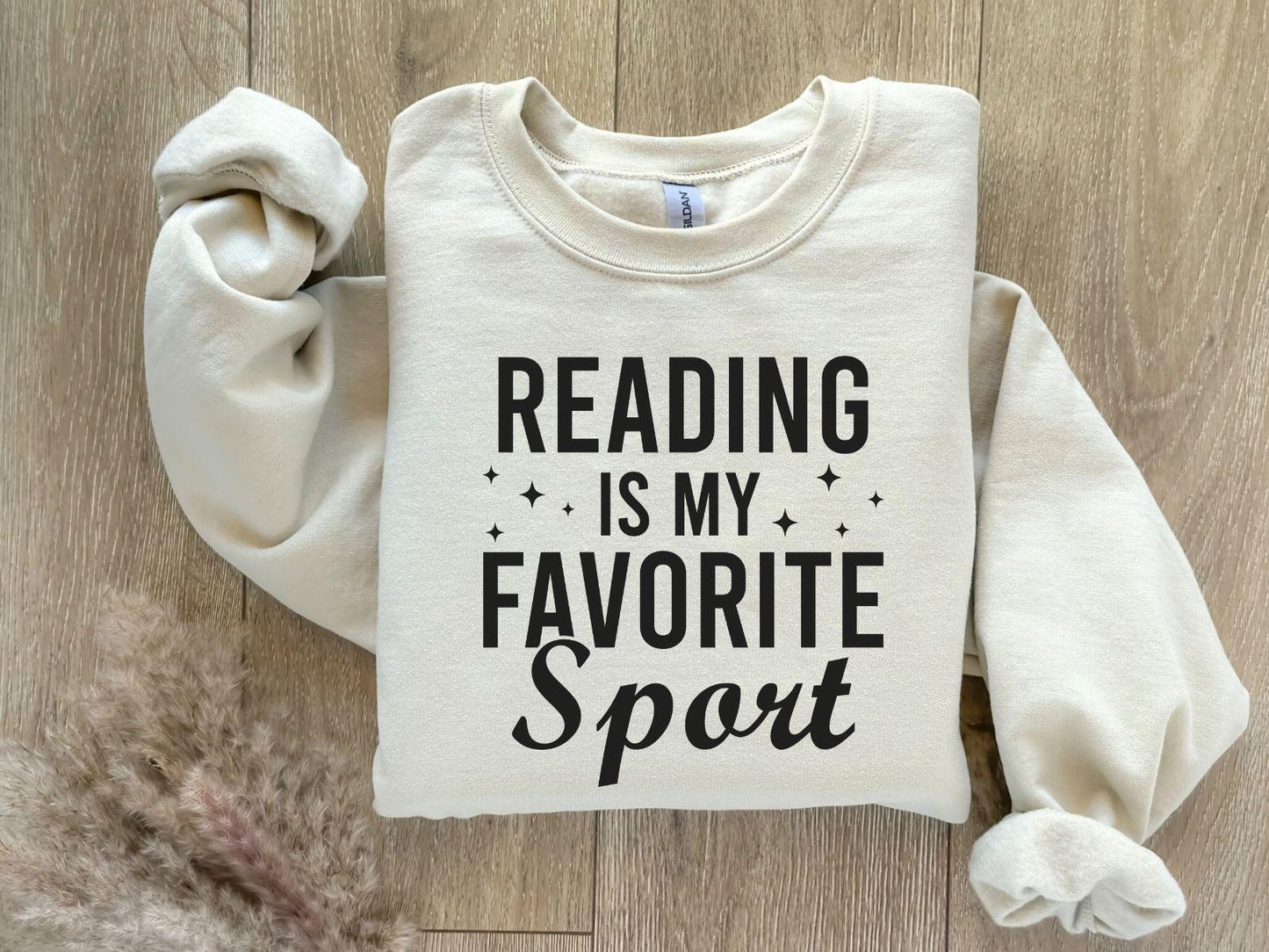 A Gildan 18000 sweatshirt with the saying "Reading is my favorite sport"