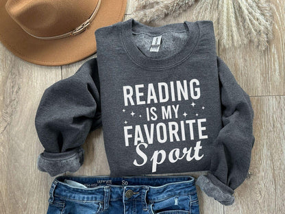 A Gildan 18000 sweatshirt with the saying "Reading is my favorite sport"