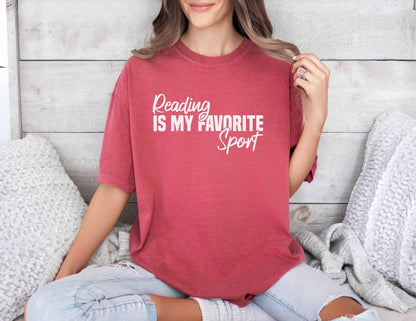 A comfort colors® shirt with the saying "Reading is my favorite sport"