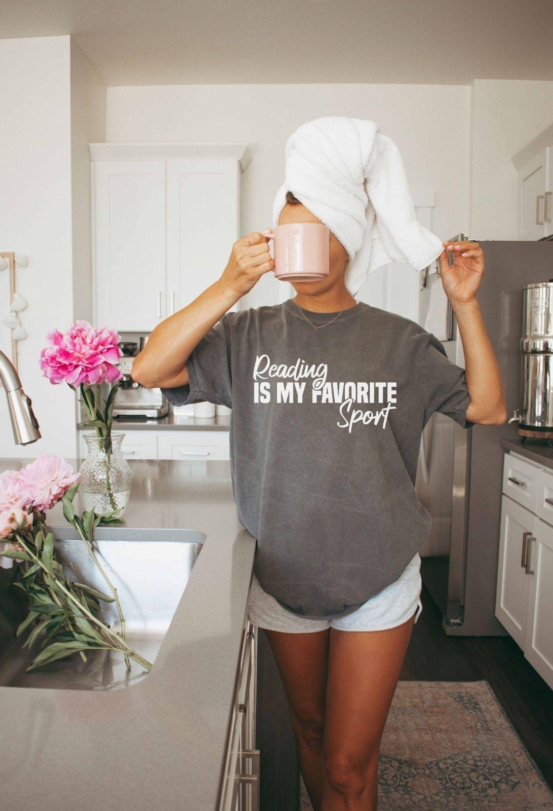 A comfort colors® shirt with the saying "Reading is my favorite sport"