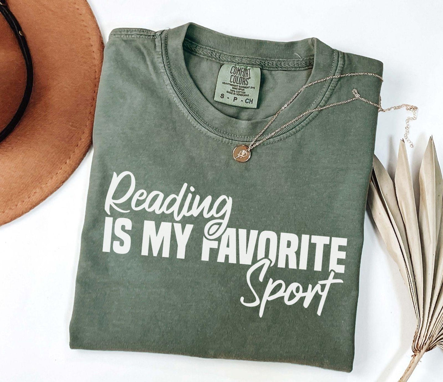 A comfort colors® shirt with the saying "Reading is my favorite sport"