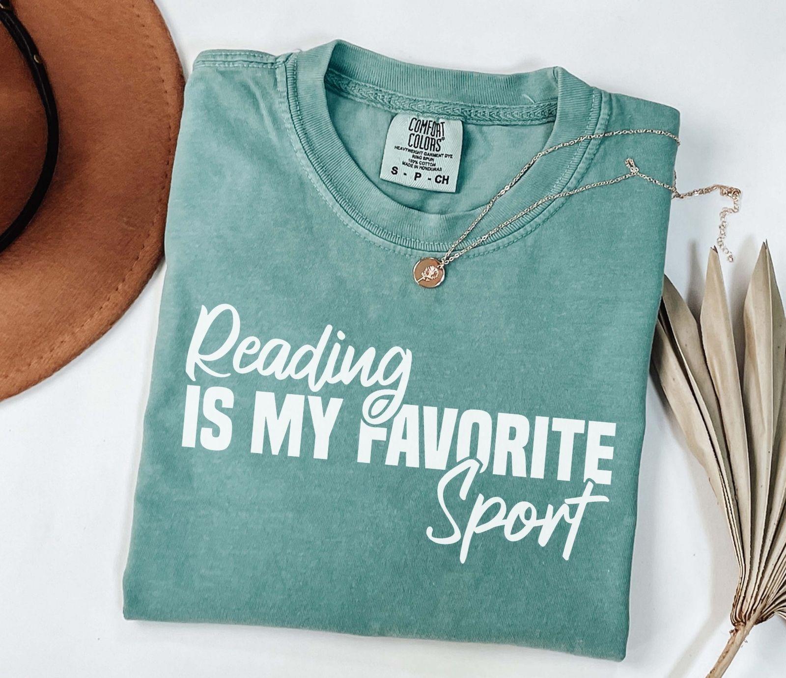 A comfort colors® shirt with the saying "Reading is my favorite sport"