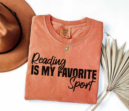 A comfort colors® shirt with the saying "Reading is my favorite sport"