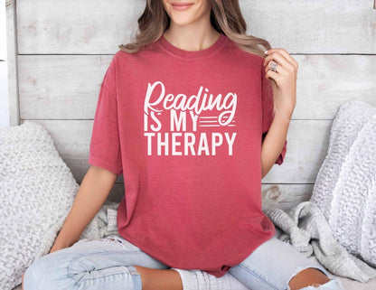 A comfort colors® shirt with the saying "Reading is my therapy"