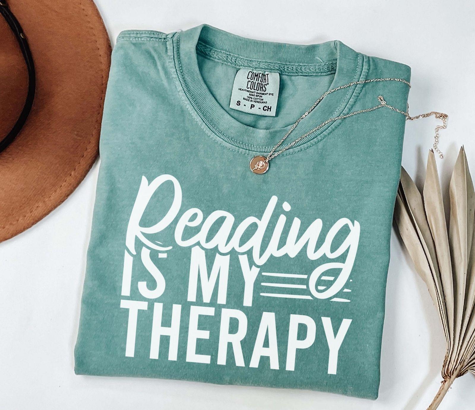 A comfort colors® shirt with the saying "Reading is my therapy"