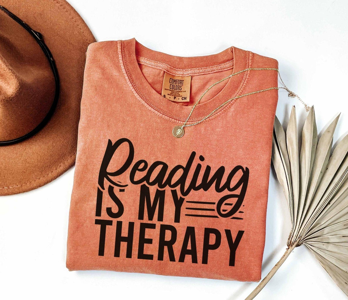 A comfort colors® shirt with the saying "Reading is my therapy"