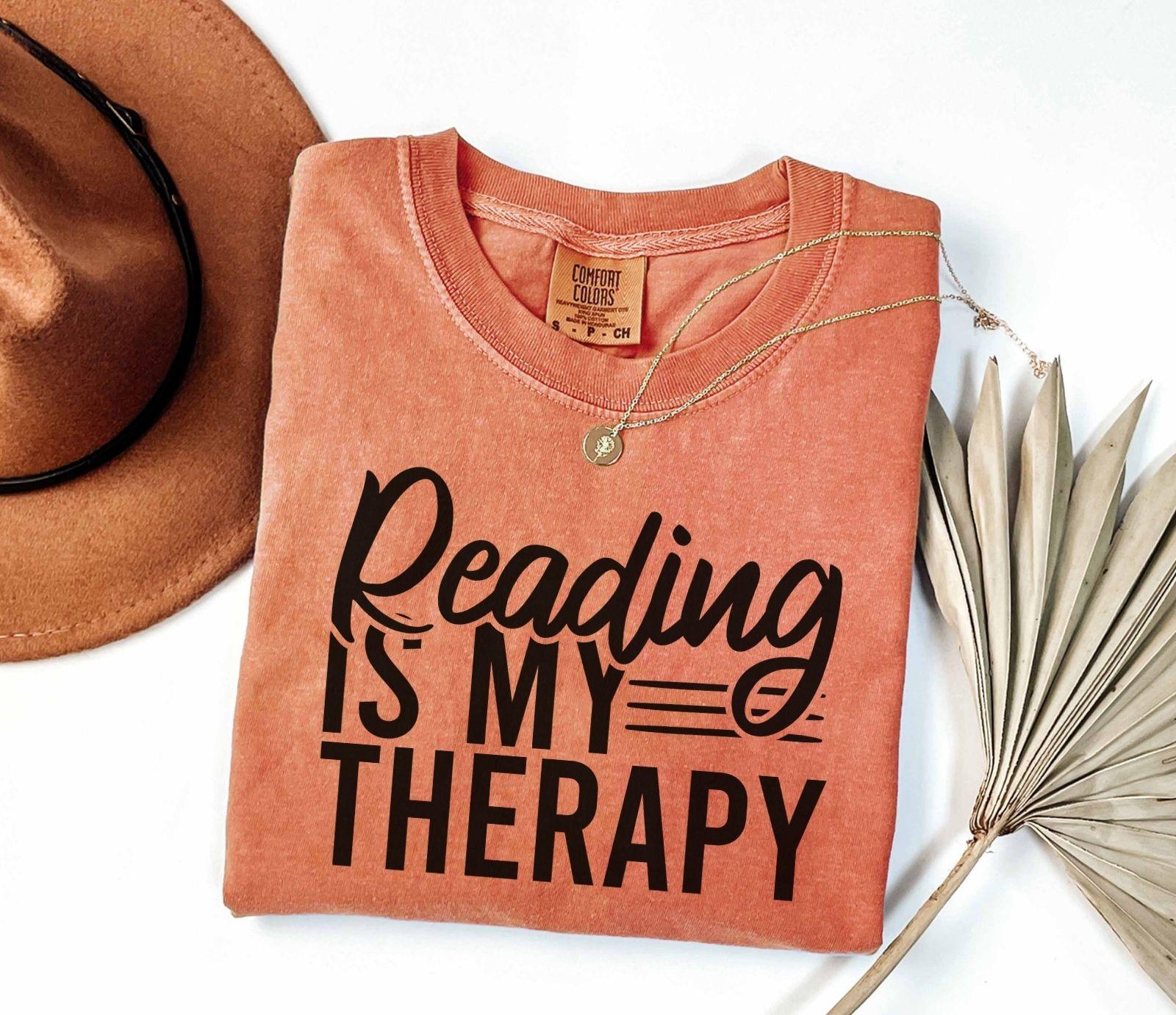 A comfort colors® shirt with the saying "Reading is my therapy"