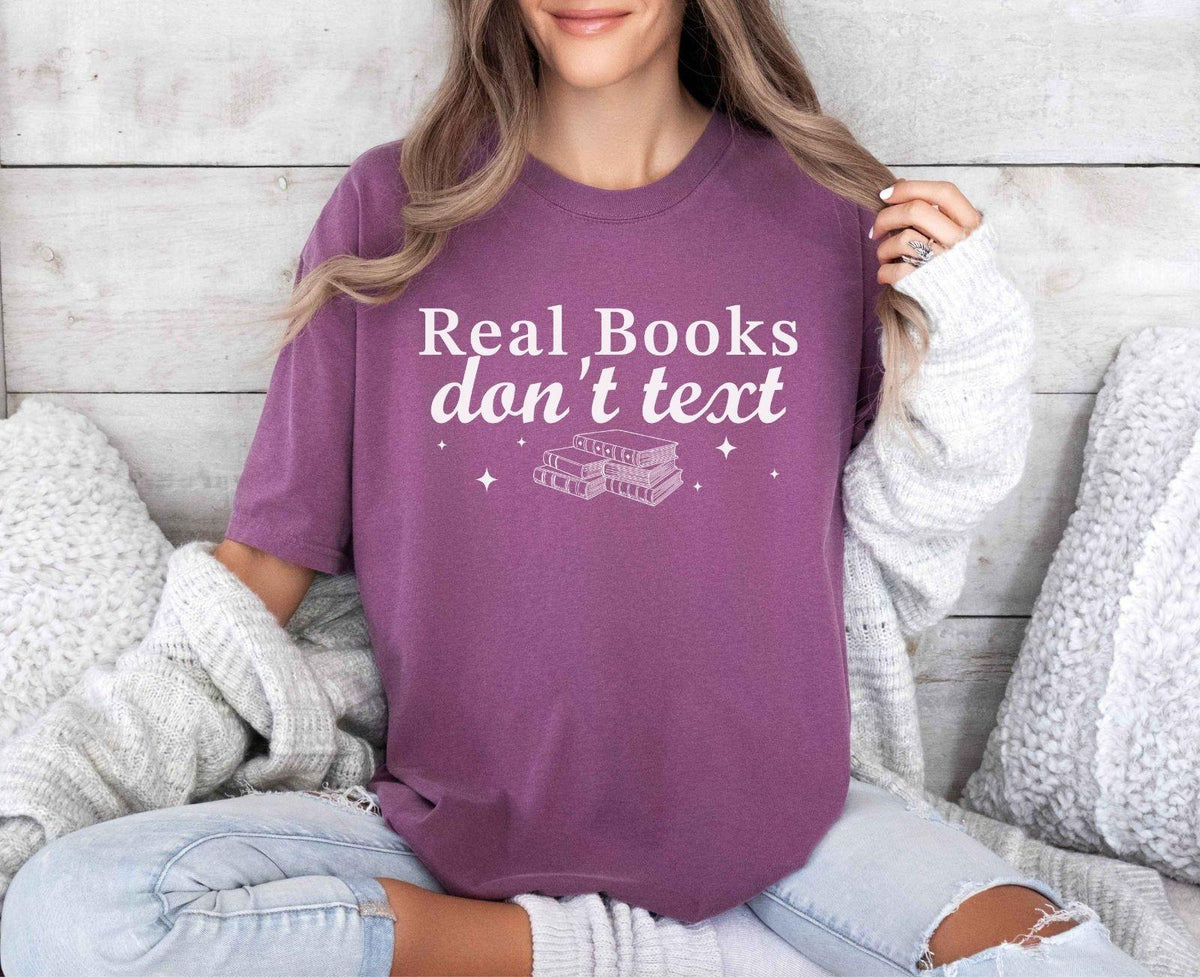 A comfort colors® shirt with the saying "Real books don't text"