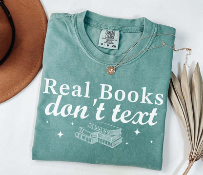 A comfort colors® shirt with the saying "Real books don't text"