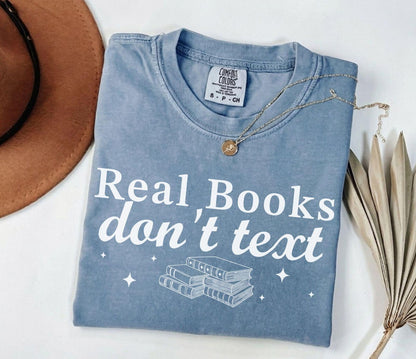 A comfort colors® shirt with the saying "Real books don't text"