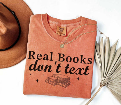 A comfort colors® shirt with the saying "Real books don't text"