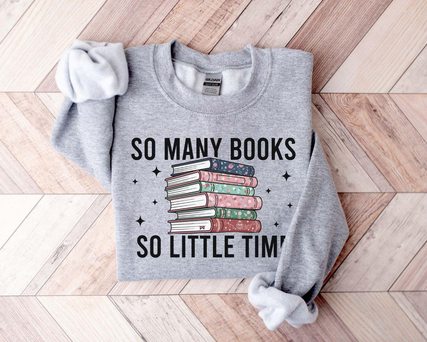 A Gildan 18000 sweatshirt with the saying "so many books so little time"