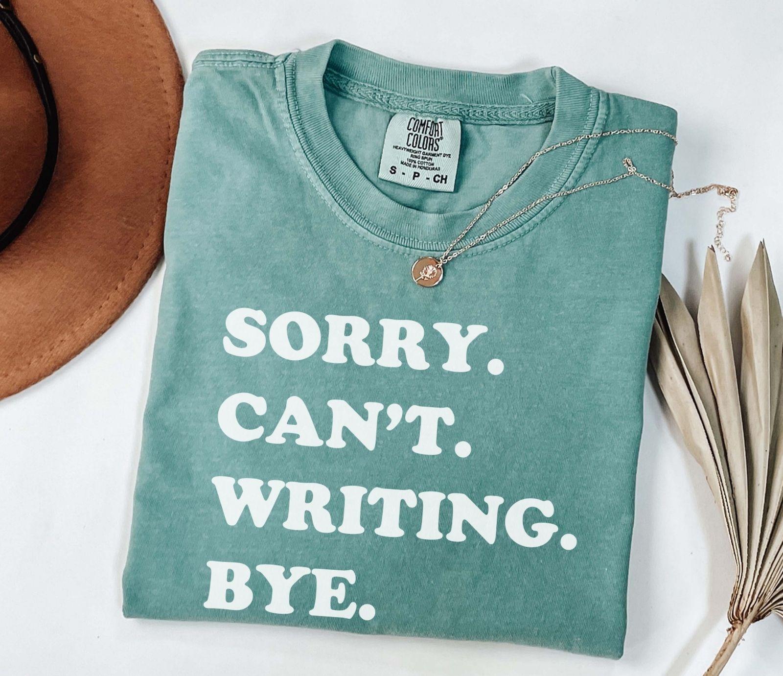 A comfort colors® shirt with the saying "sorry can't writing bye"