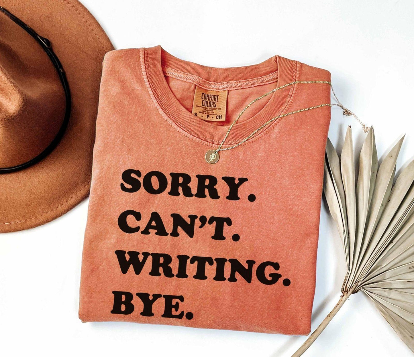 A comfort colors® shirt with the saying "sorry can't writing bye"