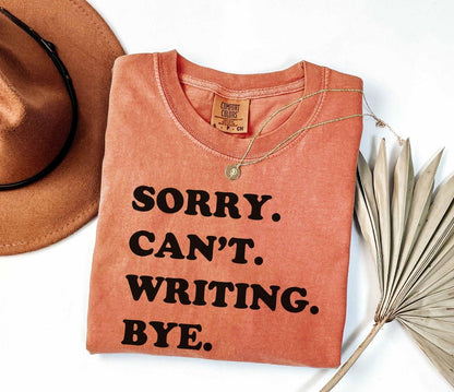A comfort colors® shirt with the saying "sorry can't writing bye"