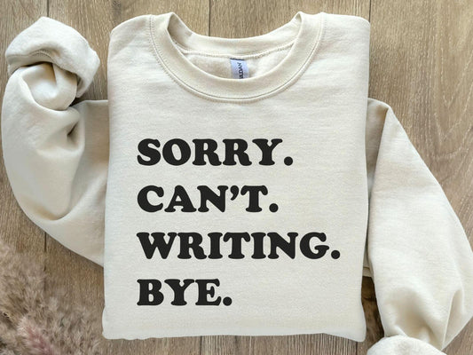 A Gildan 18000 sweatshirt with the saying "sorry can't writing bye"