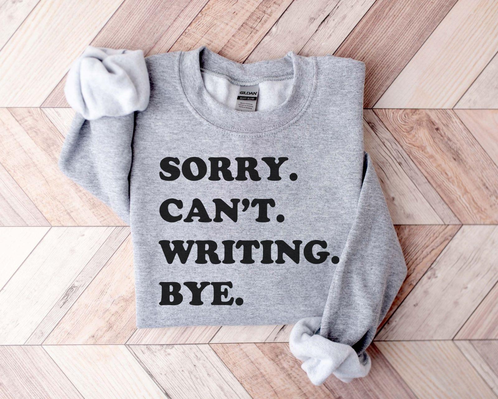 A Gildan 18000 sweatshirt with the saying "sorry can't writing bye"