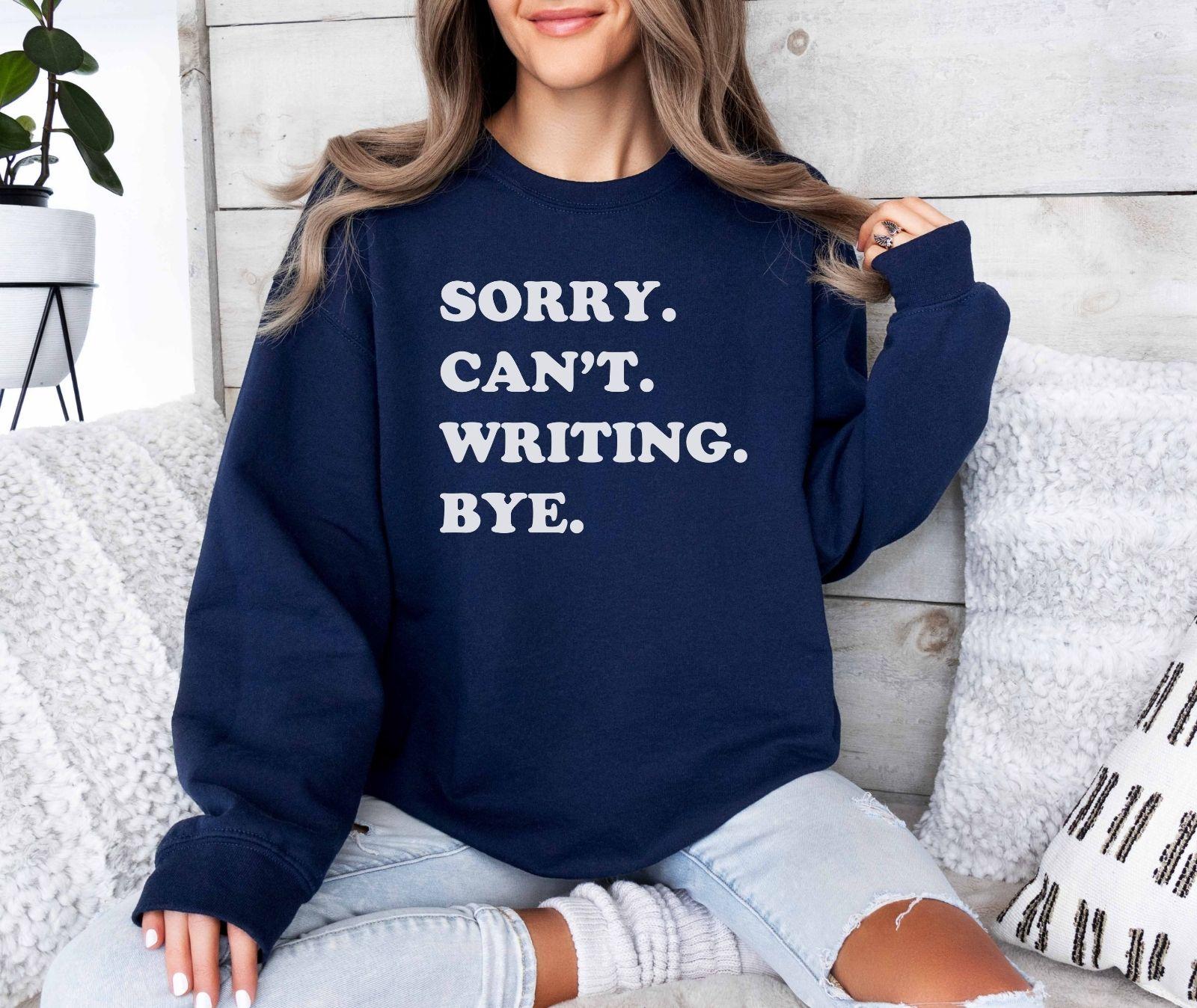 A Gildan 18000 sweatshirt with the saying "sorry can't writing bye"