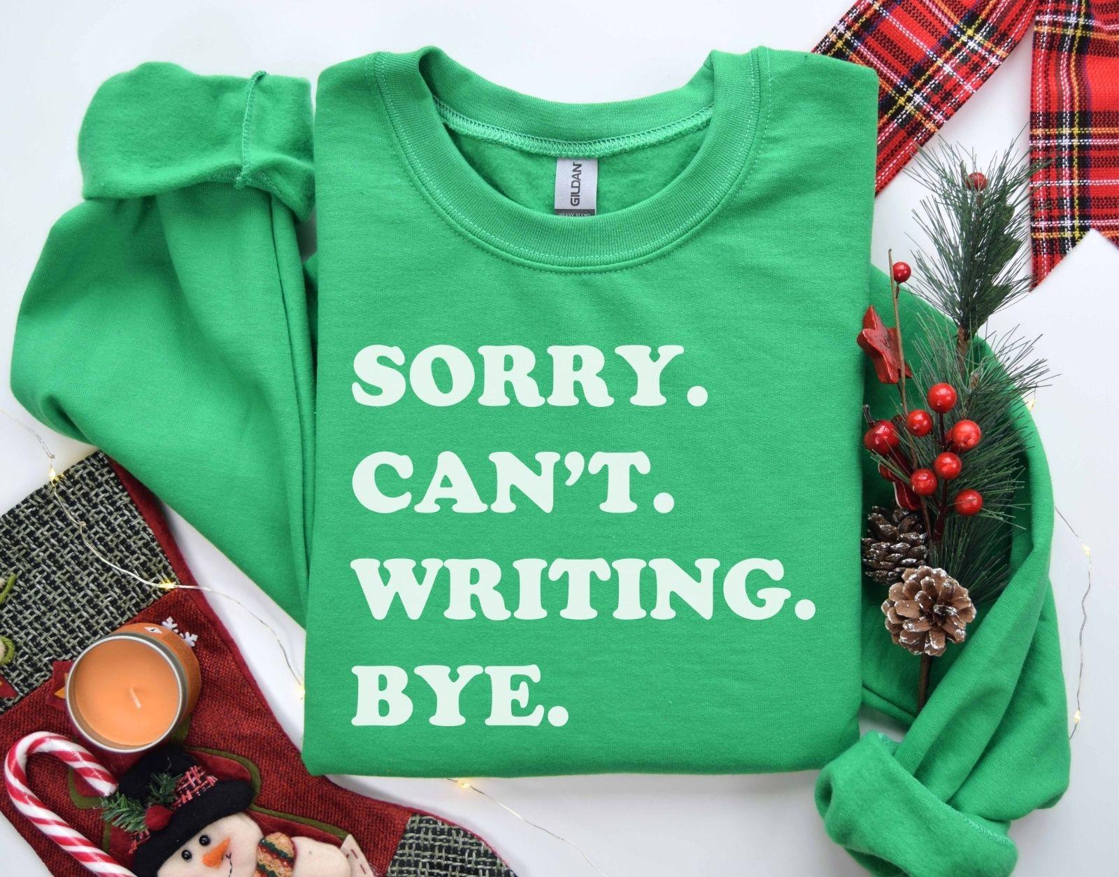 A Gildan 18000 sweatshirt with the saying "sorry can't writing bye"
