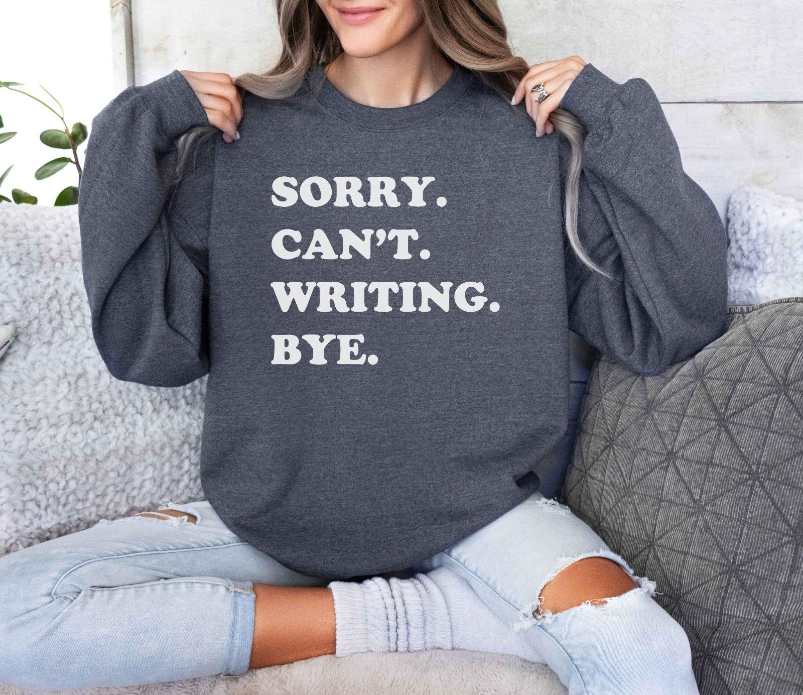 A Gildan 18000 sweatshirt with the saying "sorry can't writing bye"