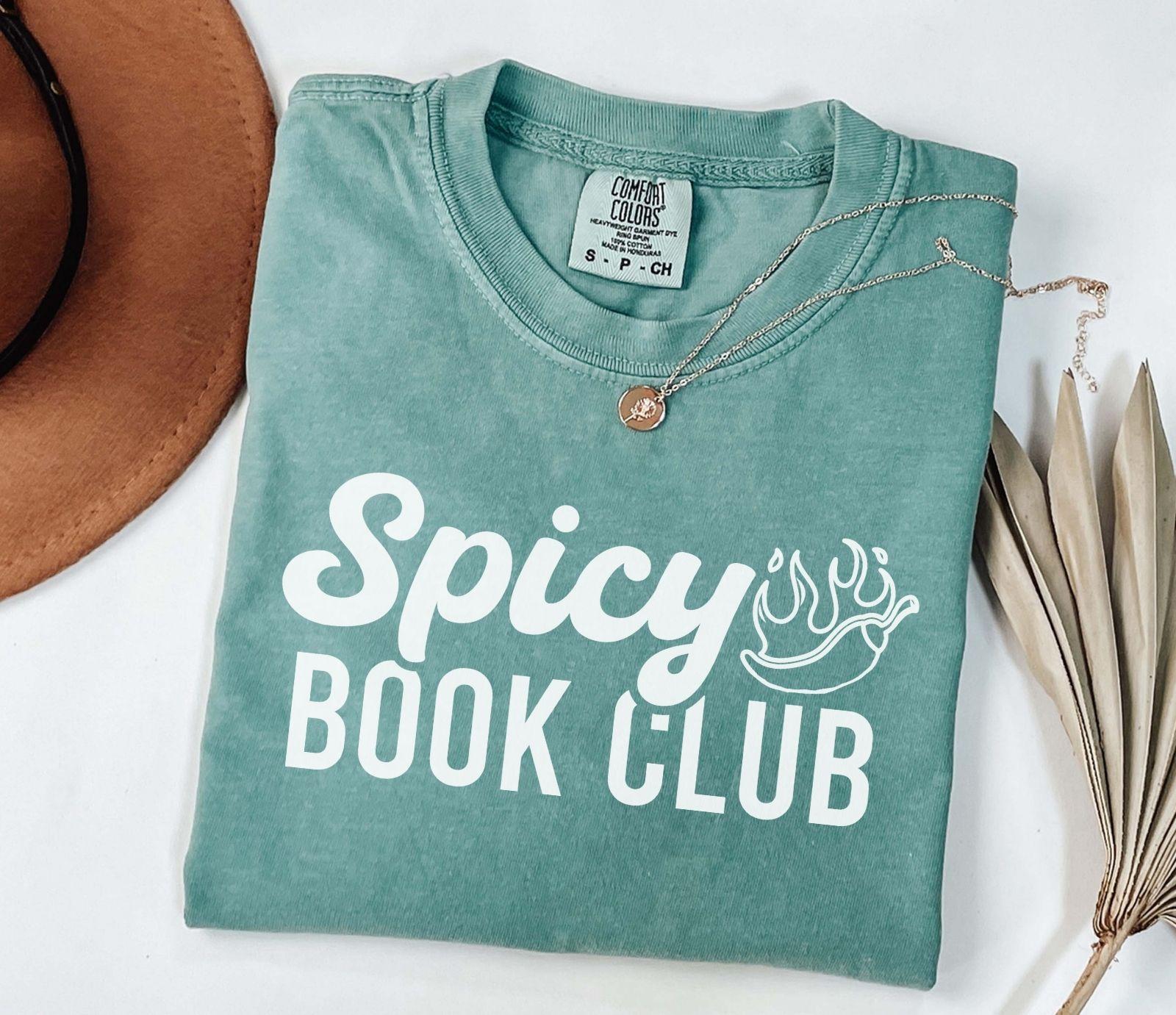 A comfort colors shirt with the saying "Spicy book club"