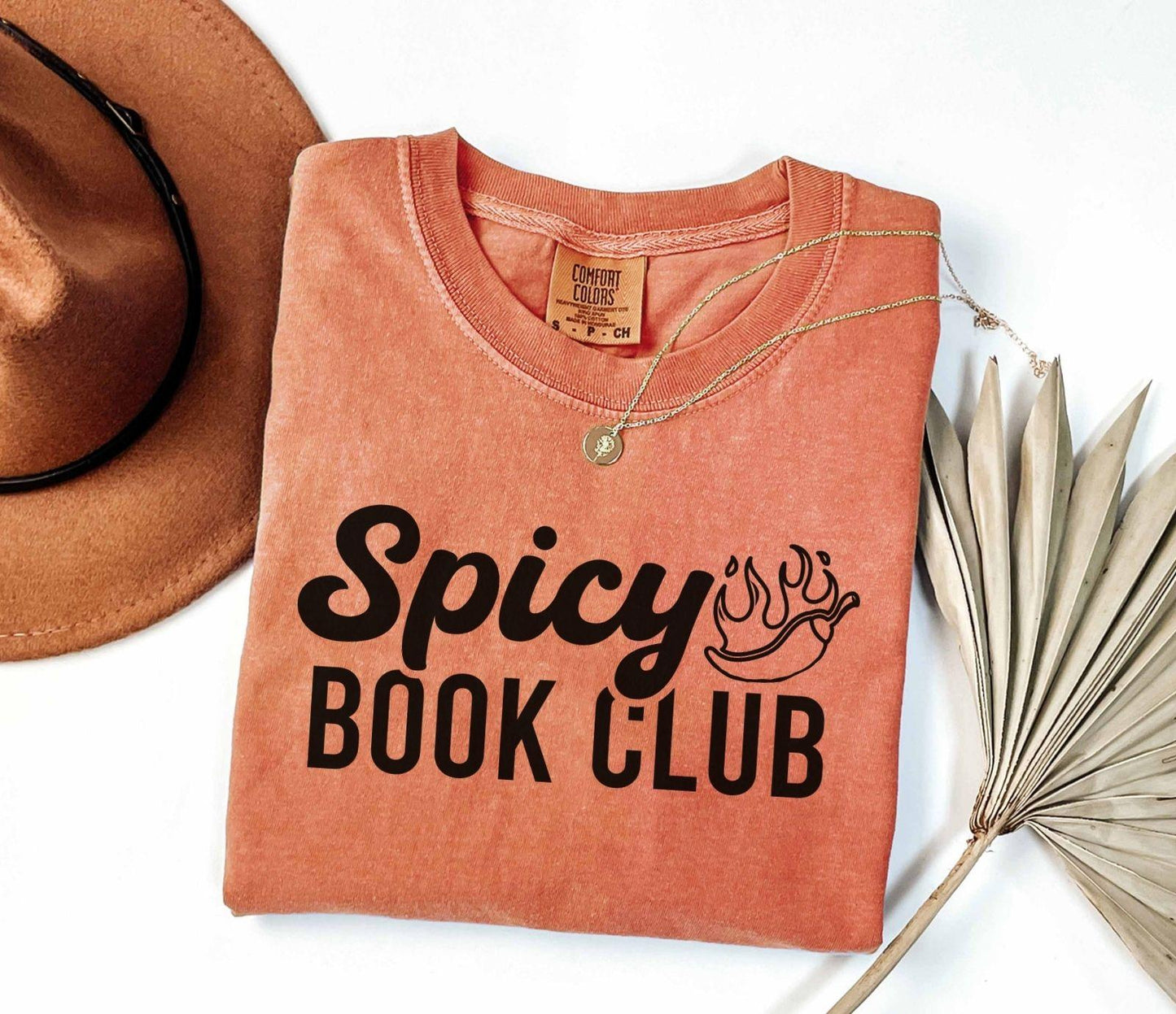 A comfort colors shirt with the saying "Spicy book club"