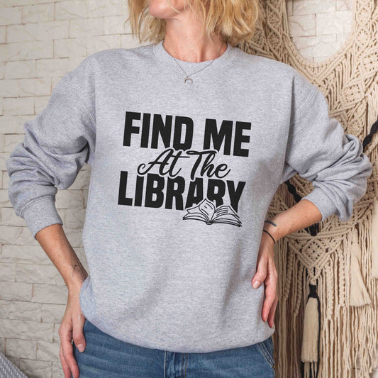 A sport grey color sweatshirt with the saying "Find me at the library"