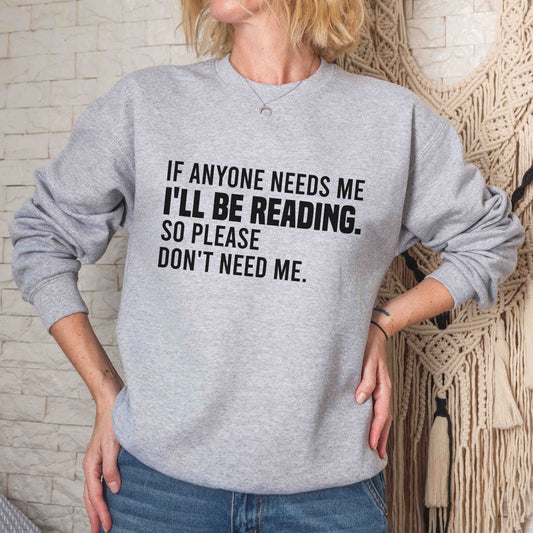 A sport grey color sweatshirt with the saying "if anyone needs me i'll be reading so please don't need me"