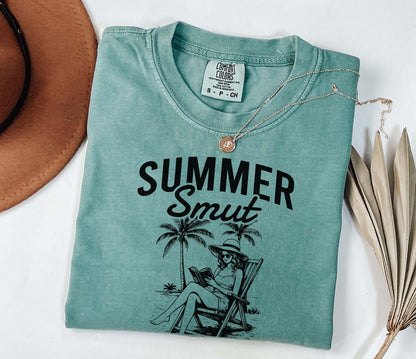 A comfort colors shirt with the saying "Summer smut kissed by the sun"