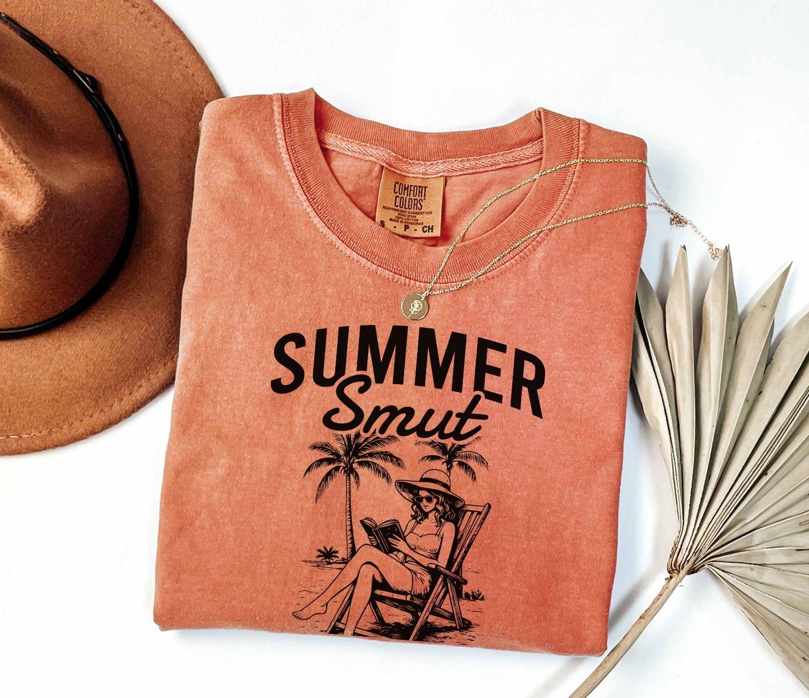 A comfort colors shirt with the saying "Summer smut kissed by the sun"