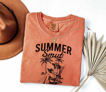 A comfort colors shirt with the saying "Summer smut kissed by the sun"