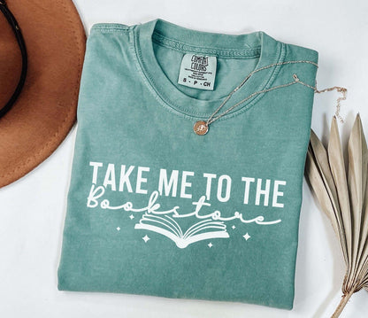 A comfort colors shirt with the saying "Take me to the bookstore"
