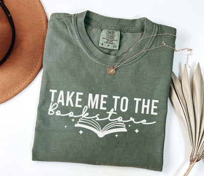 A comfort colors shirt with the saying "Take me to the bookstore"