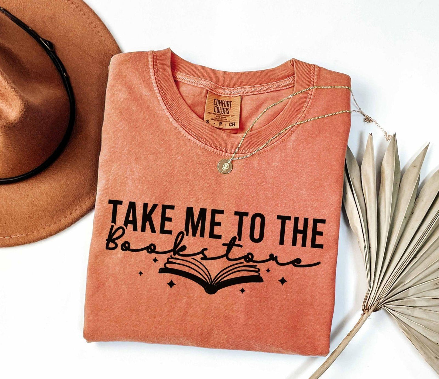 A comfort colors shirt with the saying "Take me to the bookstore"