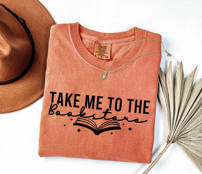 A comfort colors shirt with the saying "Take me to the bookstore"