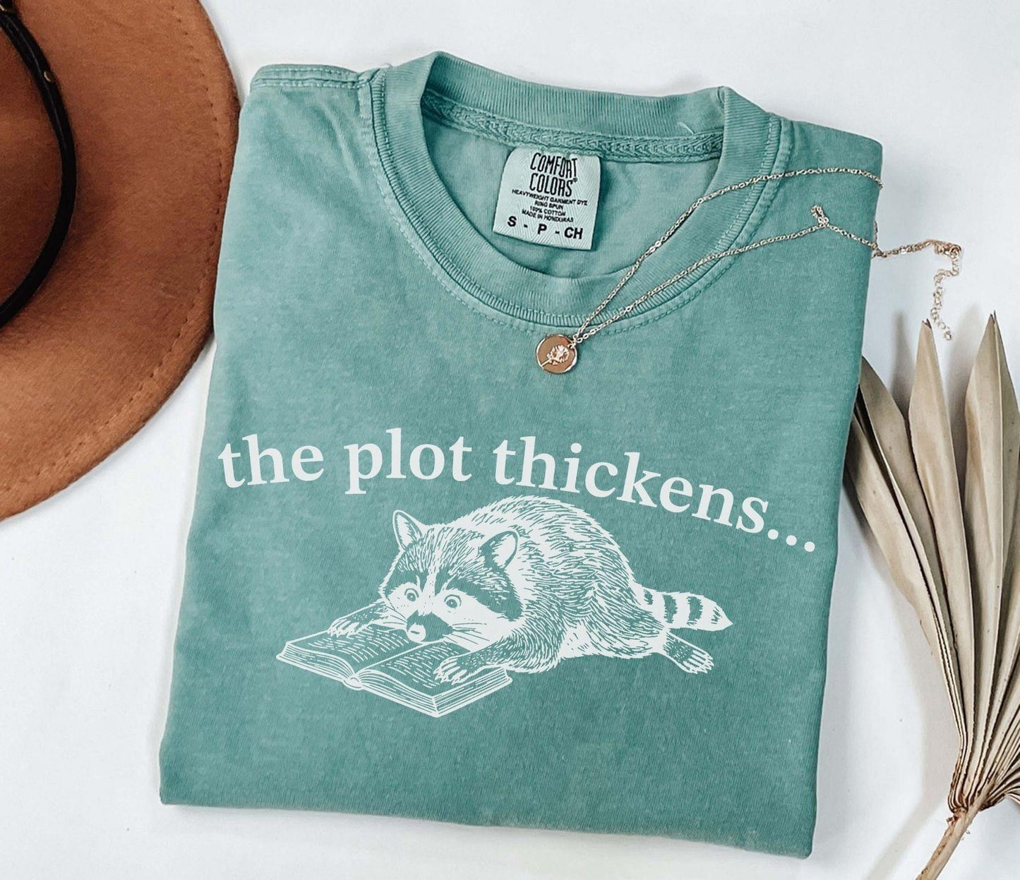 A comfort colors® shirt with the saying "the plot thickens"