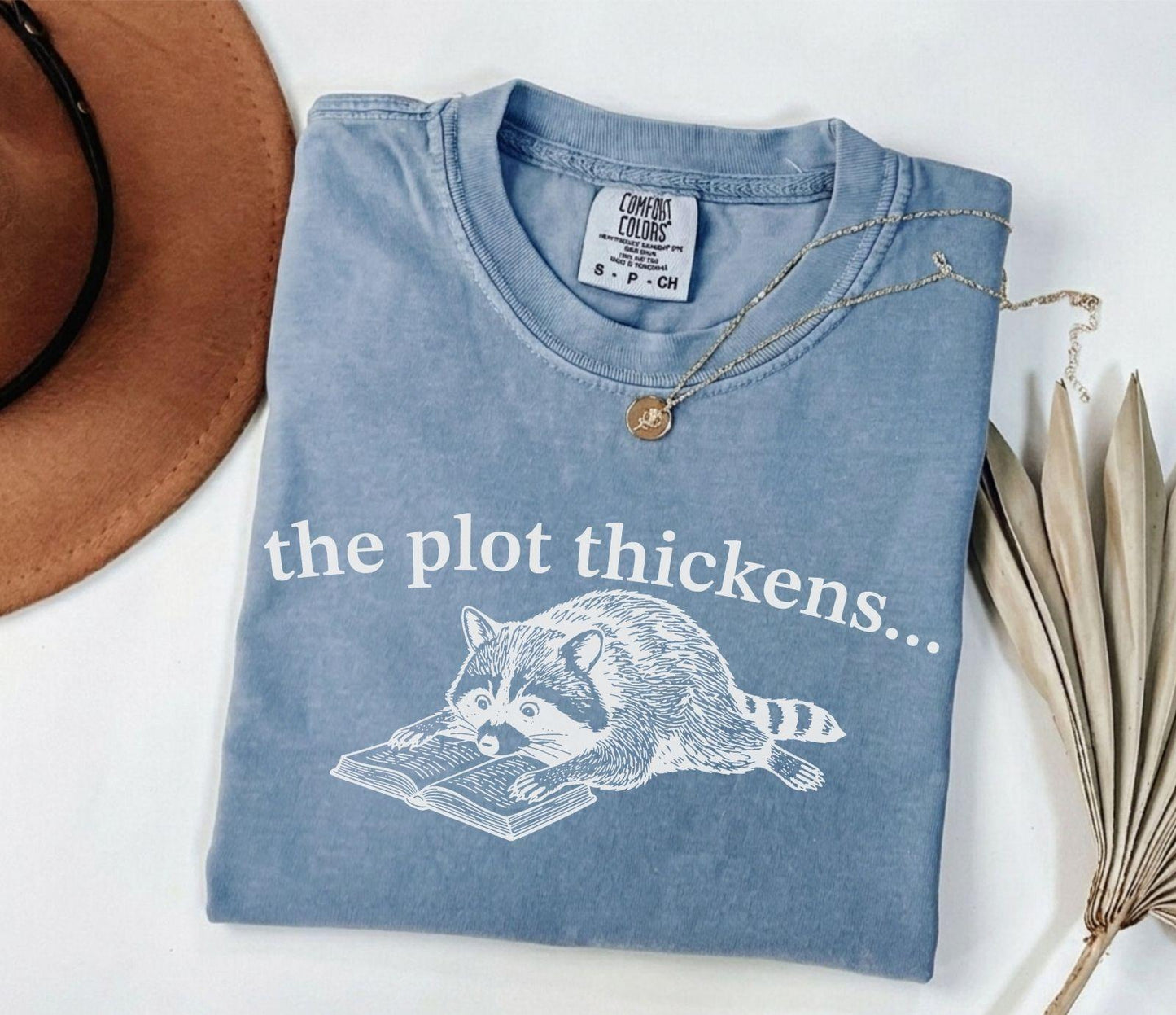 A comfort colors® shirt with the saying "the plot thickens"