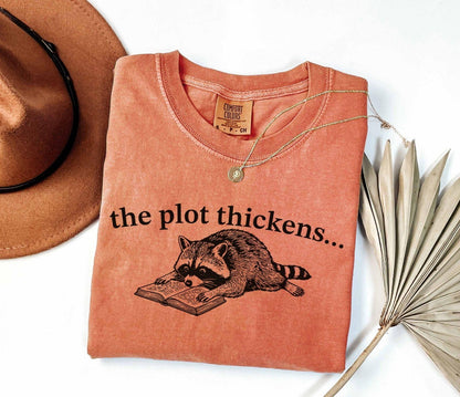 A comfort colors® shirt with the saying "the plot thickens"