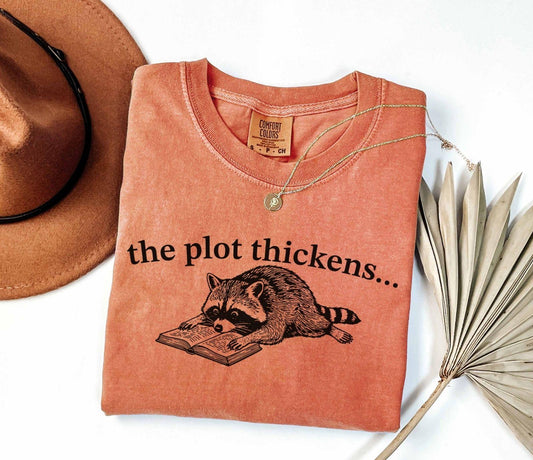 A comfort colors® shirt with the saying "the plot thickens"