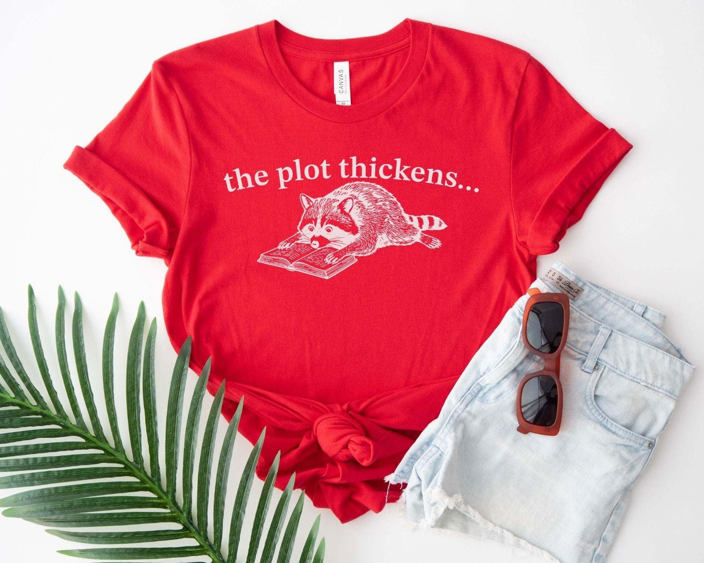 A bella canvas 3001 shirt with the saying "file:///Users/zakaria-bassim-elidrissi/Documents/Etsy/Shopify%20designs/the%20plot%20thickens"