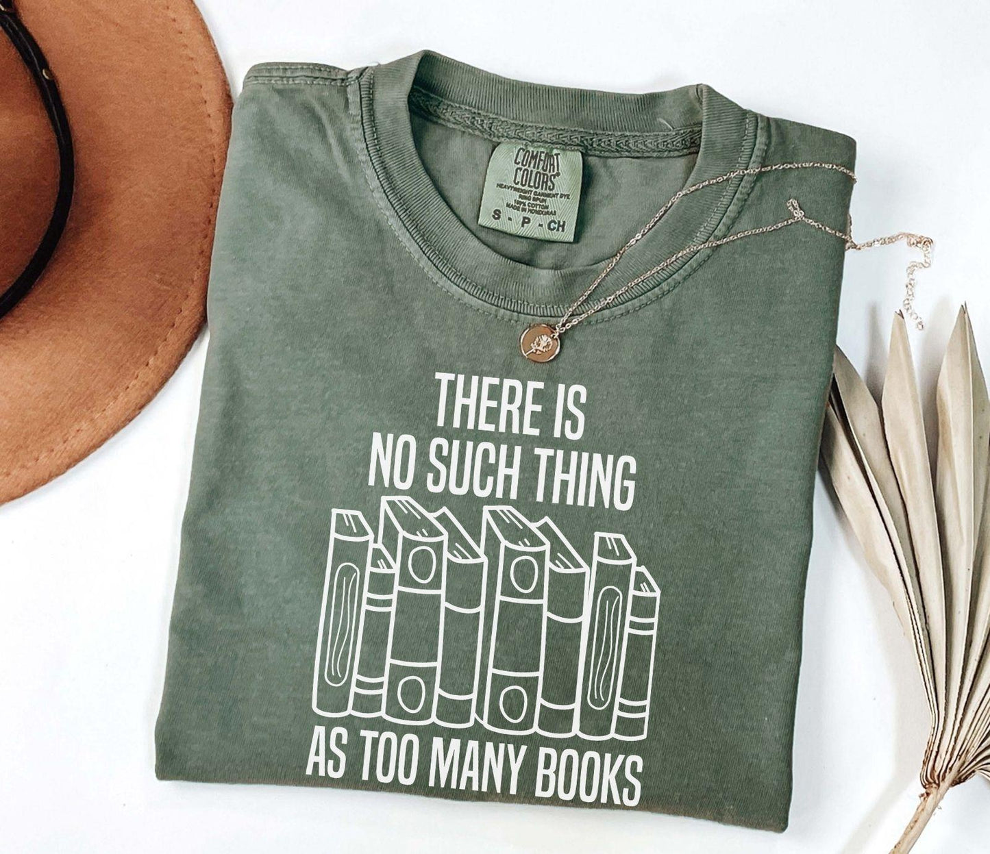 A comfort colors® shirt with the saying "There Is No Such Thing As Too Many Books"