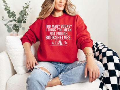 A Gildan 18000 sweatshirt with the saying "too many books I think you mean not enough bookshelves"
