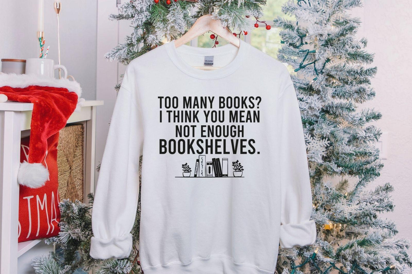 A Gildan 18000 sweatshirt with the saying "too many books I think you mean not enough bookshelves"