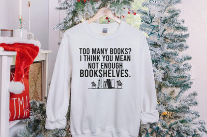 A Gildan 18000 sweatshirt with the saying "too many books I think you mean not enough bookshelves"