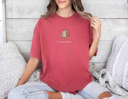 A comfort colors® shirt with the saying "we read at dawn"