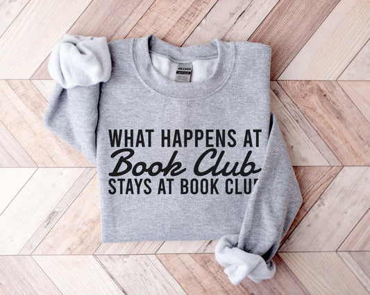 A comfort colors® shirt with the saying "what happens at book club stays at book club"