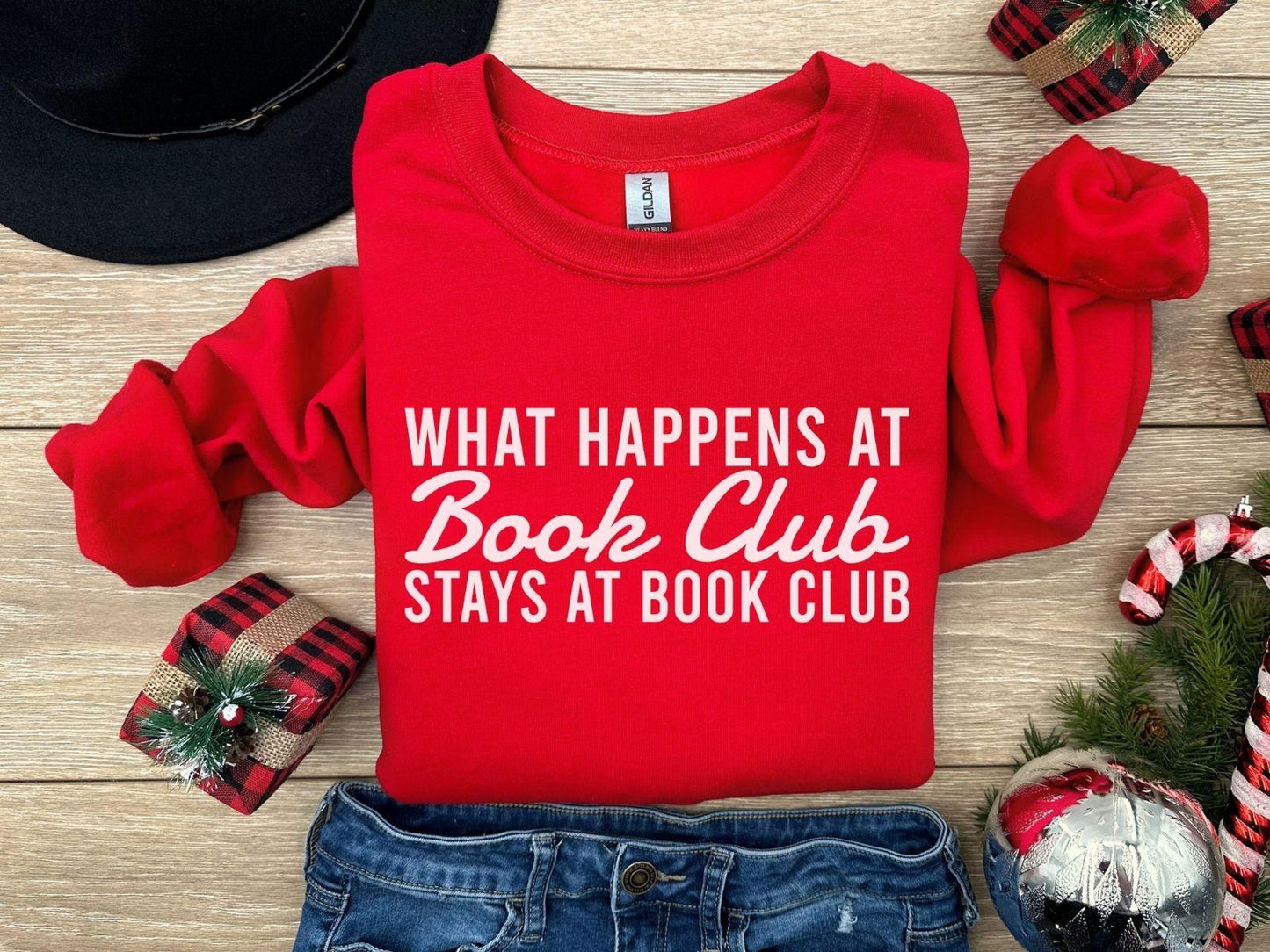 A comfort colors® shirt with the saying "what happens at book club stays at book club"